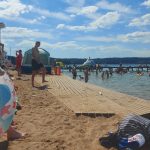 Plaże pełne korzystających z kąpieli słonecznych i wodnych